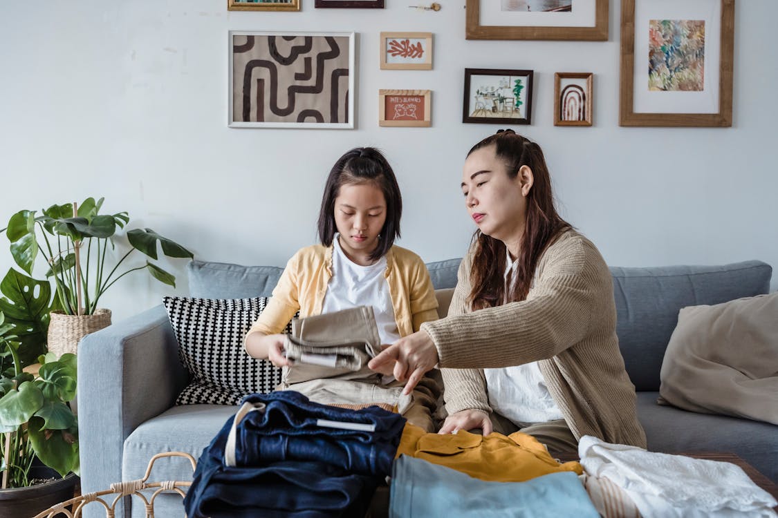 Family folding laundry together at home