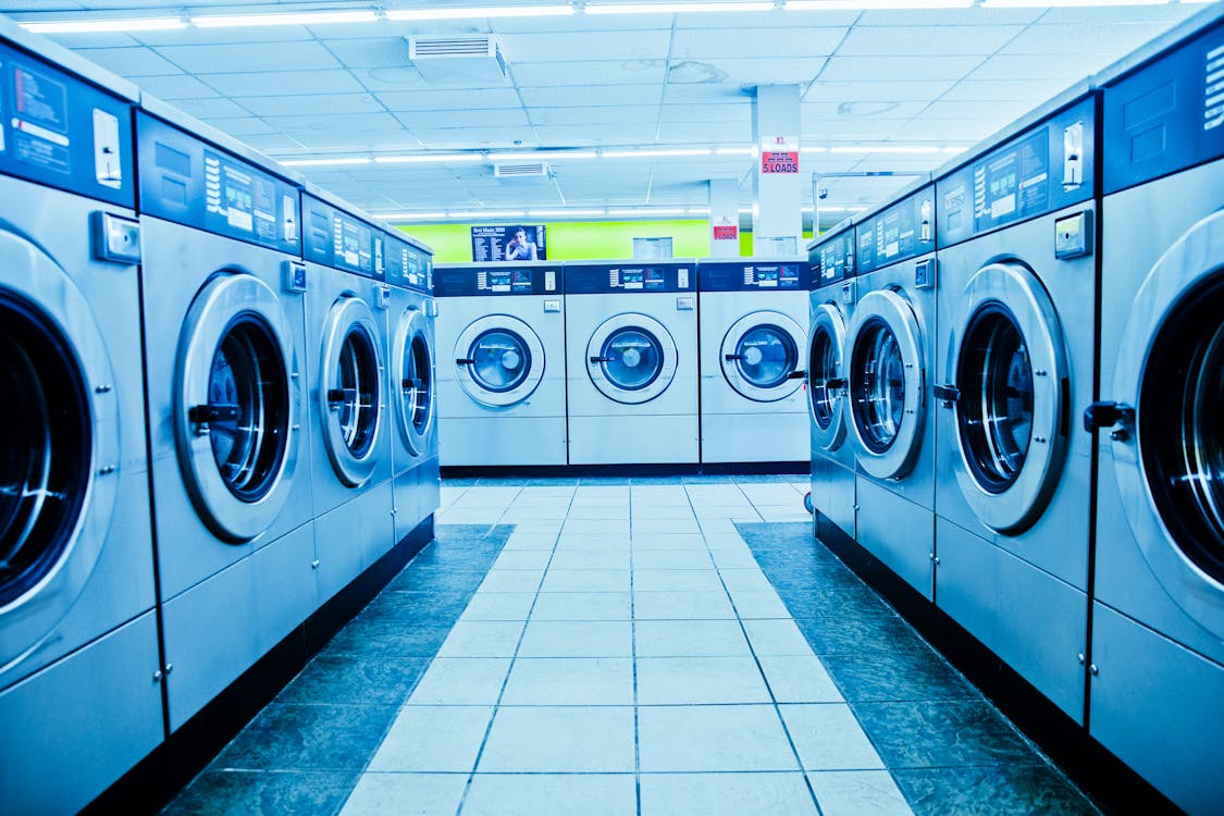 Rows of washing machines inside a laundromat