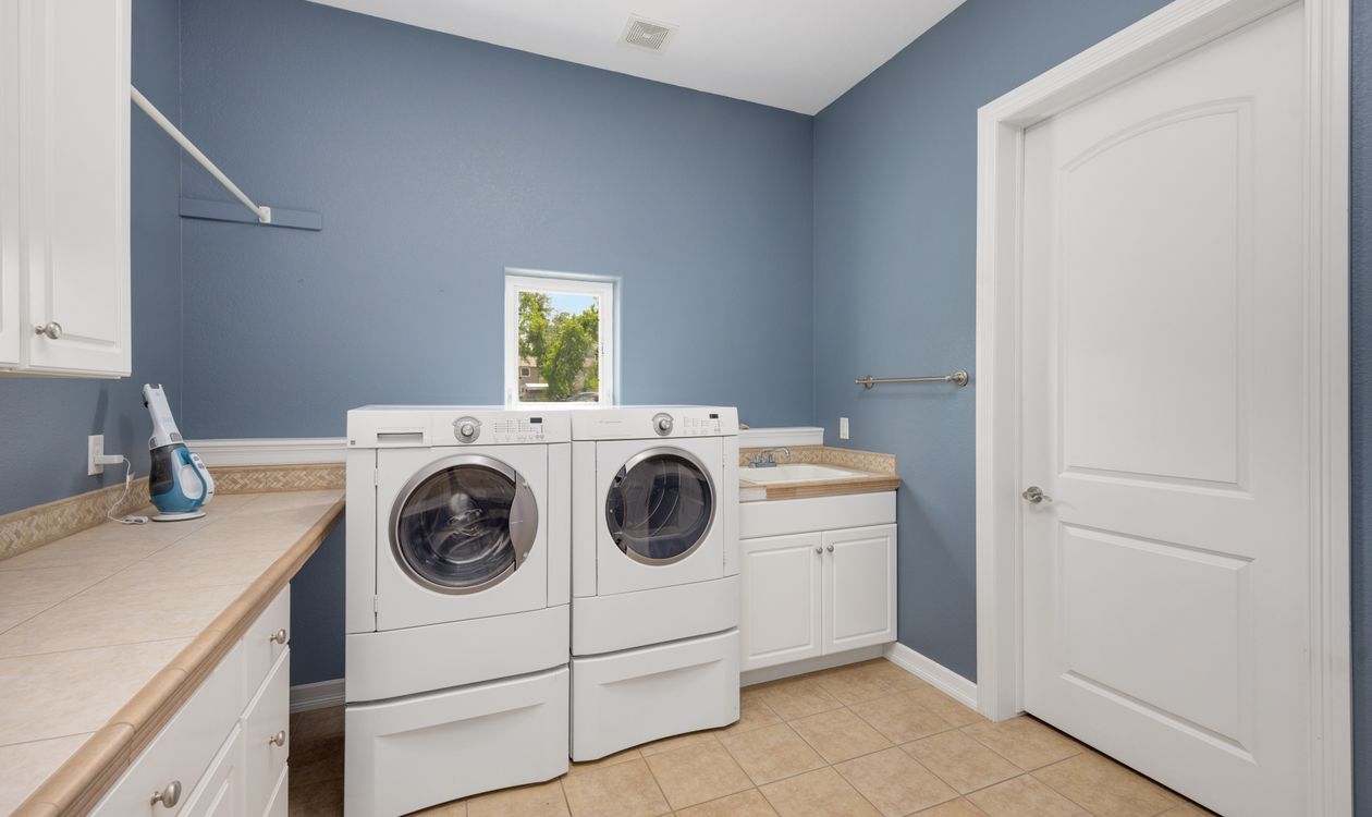Front-load washer and dryer set installed in a home laundry room